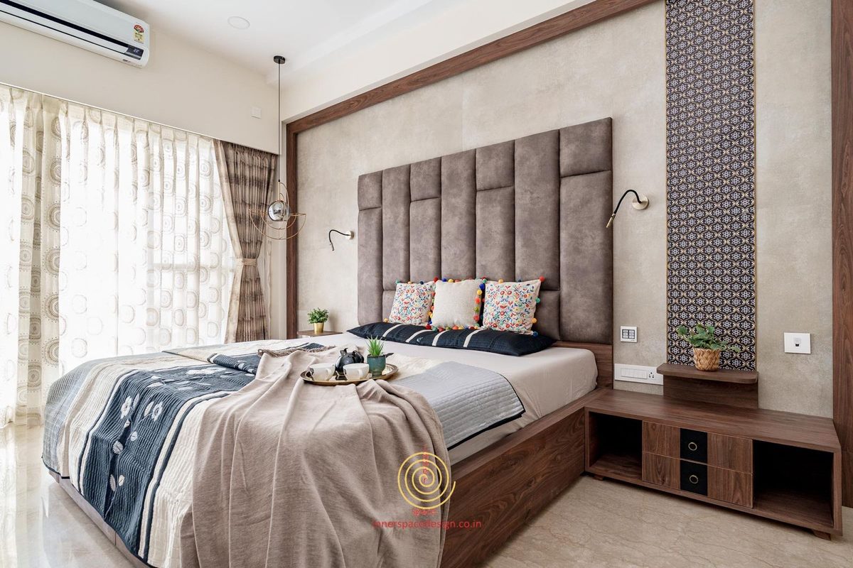 Bedroom with a channelled grey headboard, patterned wall strip and a bedside unit built into the panelling