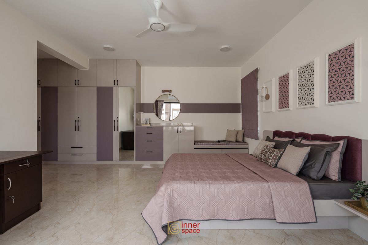 Bedroom with full-height wardrobes, a dressing counter and a padded window seat