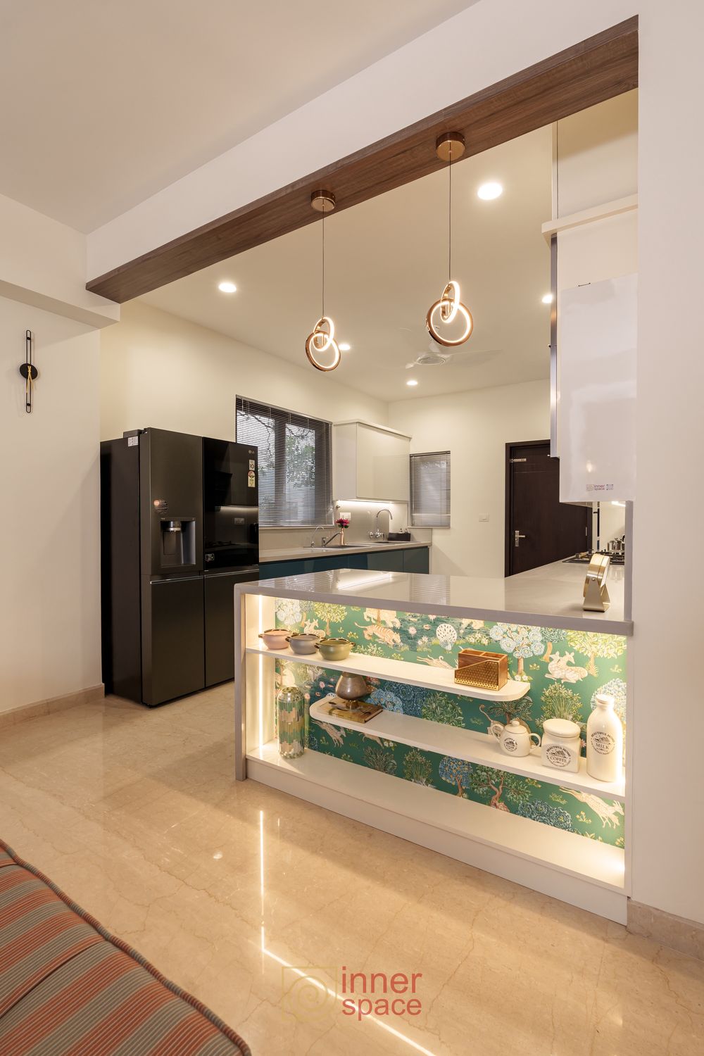 Open kitchen in a Bangalore home with a lit display counter separating it from the living area